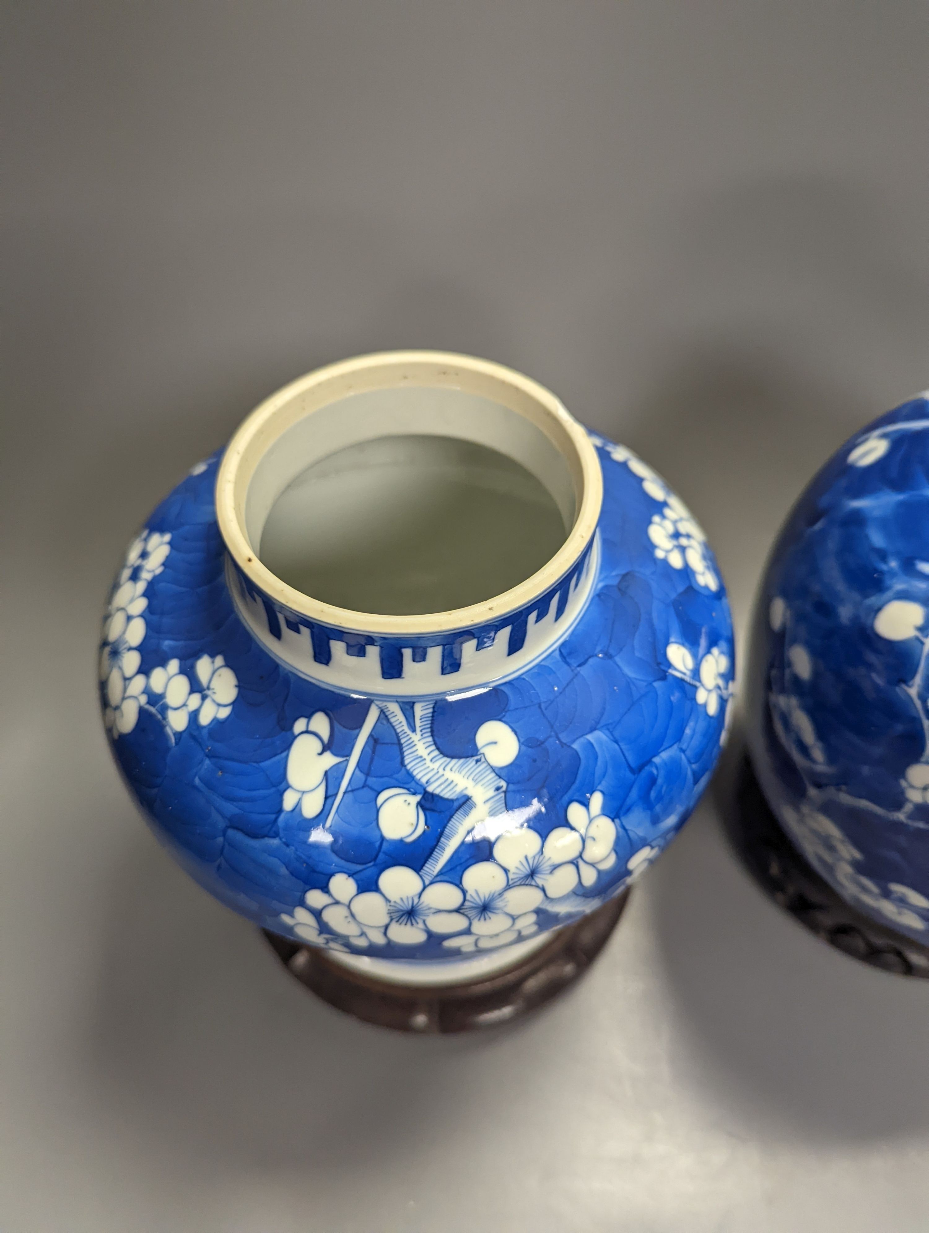 An 18th century Chinese blue and white prunus baluster jar and associated cover and a 19th century ginger jar, tallest 27cm incl. stand